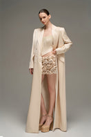 Beige double-breasted long coat by I.H.F Studio featuring an oversized, straight-cut design, displayed on a hanger.