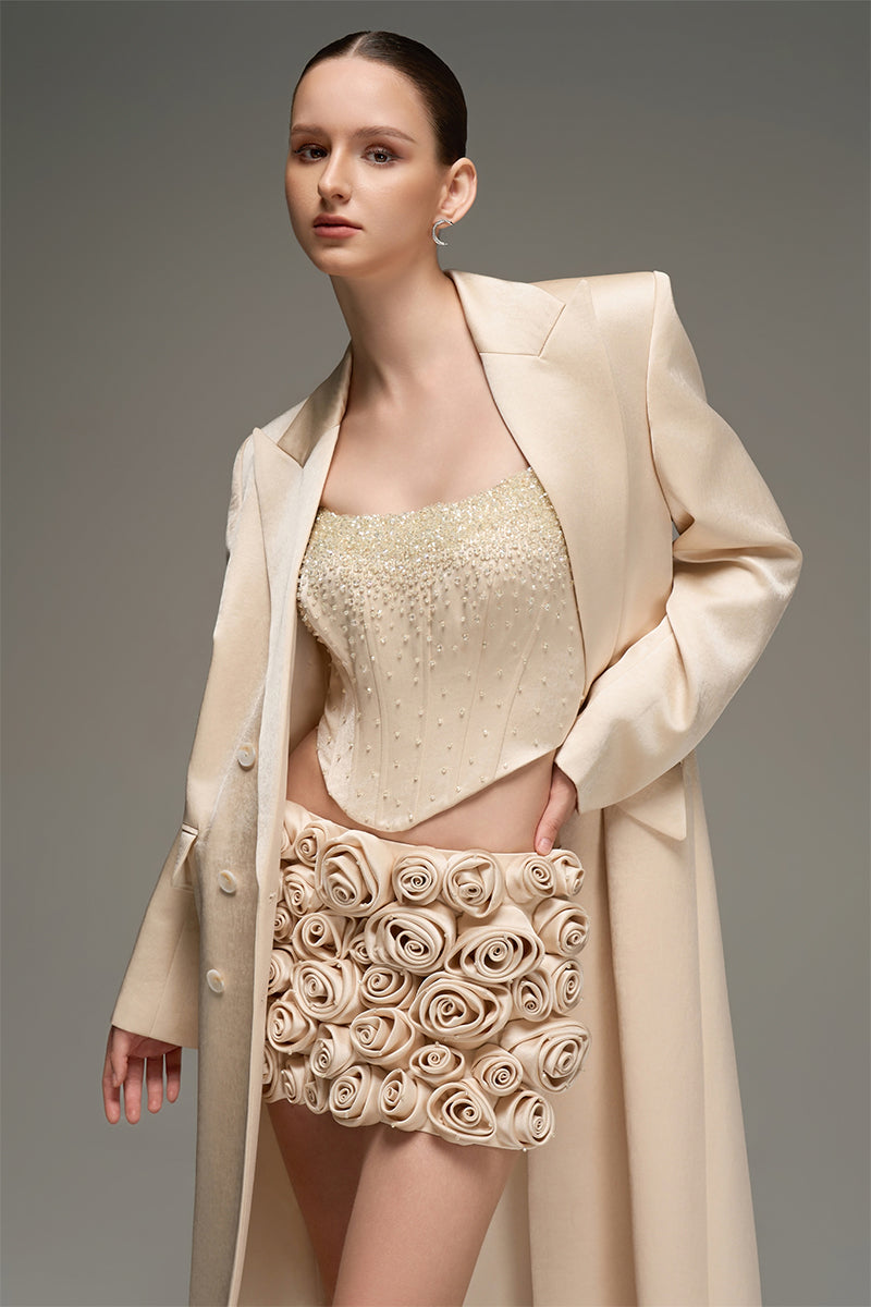 Beige corset top and embroidered skirt co-ords by I.H.F Studio, featuring a fitted corset and flowing embroidered skirt.