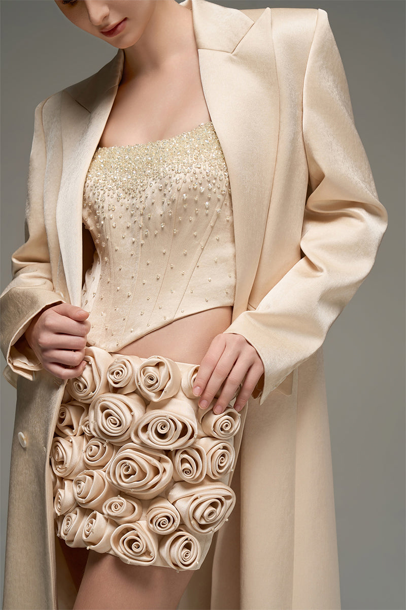 Beige corset top and embroidered skirt co-ord set from I.H.F Studio, featuring a stylish oversized long straight-cut coat.