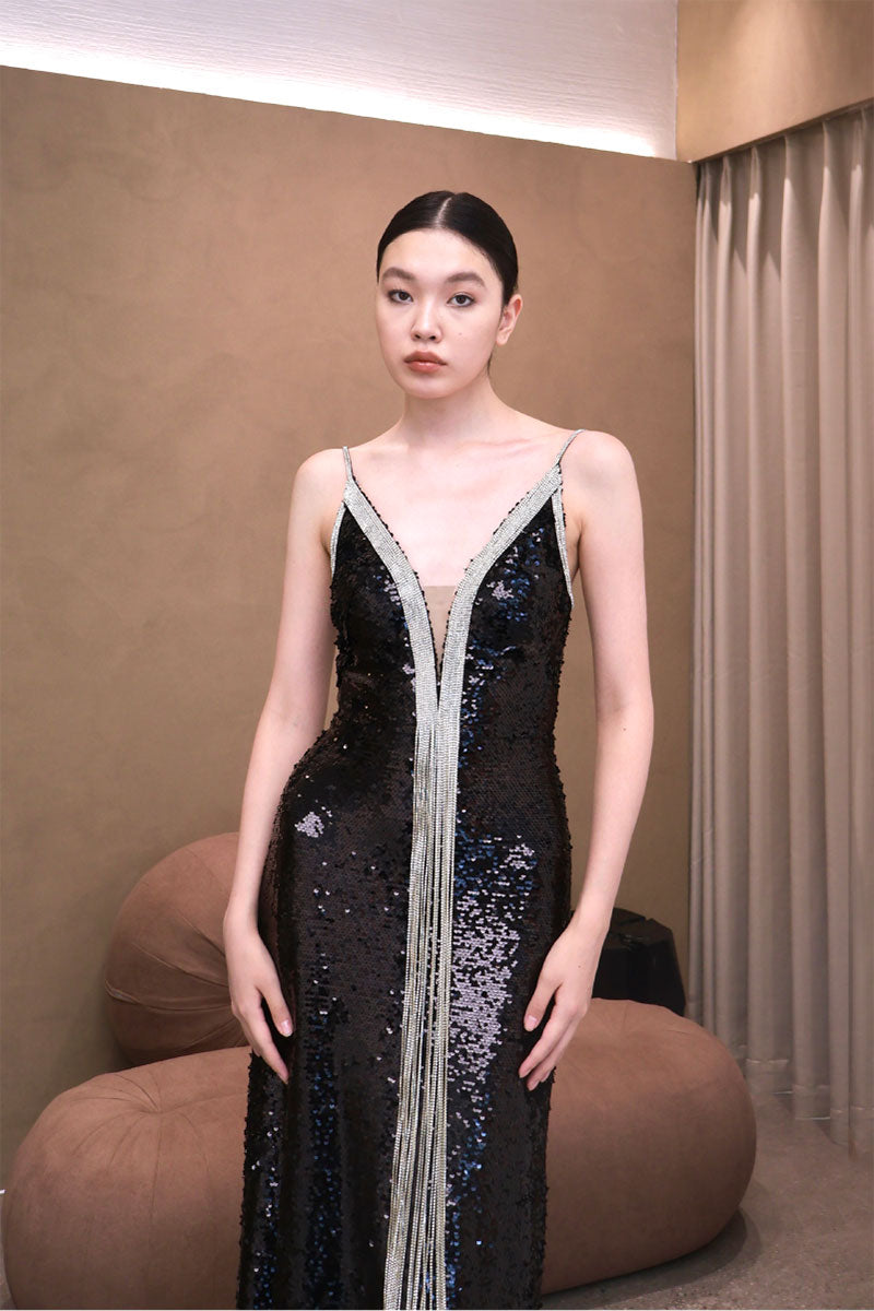 Elegant AZMIRA dress gown by EEGEN STUDIO featuring flowing fabric and intricate detailing, shown on a neutral background.