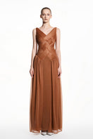 Beige sheer chiffon gown by EEGEN STUDIO featuring flowing fabric and elegant design, perfect for formal occasions.