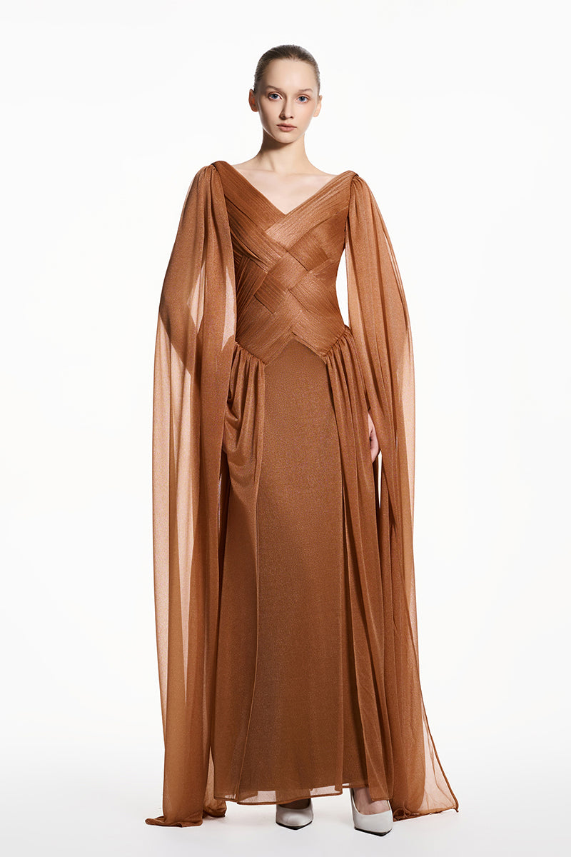 Beige sheer chiffon maxi dress by EEGEN STUDIO featuring flowing fabric and elegant silhouette.