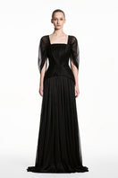 Black sheer chiffon gown by EEGEN STUDIO featuring a fitted spandex design, flowing fabric, and elegant draping.