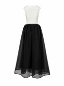 Black and white LINNEA gown by EEGEN STUDIO, elegant long dress with flowing fabric and subtle design details.