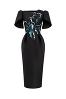 Hand-painted black Luminous Secret midi dress by Tiny Ink, featuring elegant design and flowing fabric for stylish occasions.