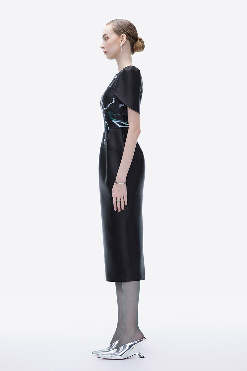 Hand-painted black Tiny Ink luminous secret midi dress shown, featuring elegant design and artistic details for stylish evening wear.