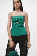 Black long JC Pajares eyelet pants with metal eyelets and tailored fit, shown on a hanger with a plain background.