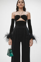 Black cut-out top with interchangeable sleeves from JC Pajares, showcasing a stylish design with modern cut-out details.
