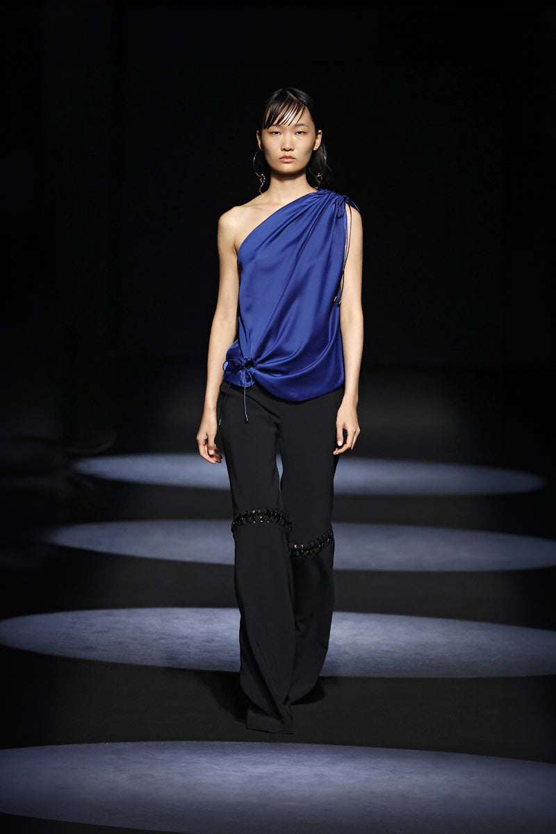 Stylish JC Pajares pants with chain accents, featuring a modern runway-inspired design and a fashionable, edgy look.