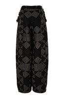 Pattern baggy trousers by MAZ Manuela Álvarez with a loose fit and bold pattern, shown on a model in a casual setting.