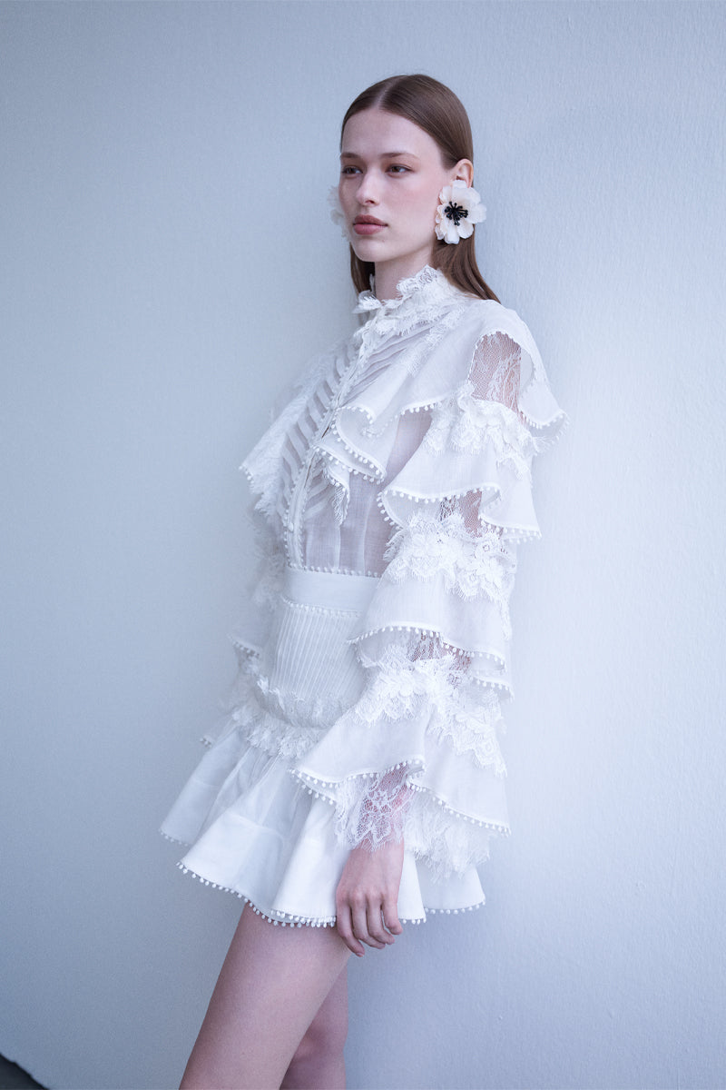 AISA pearl shirt featuring a stylish design with pearly accents, shown on a hanger against a plain background.