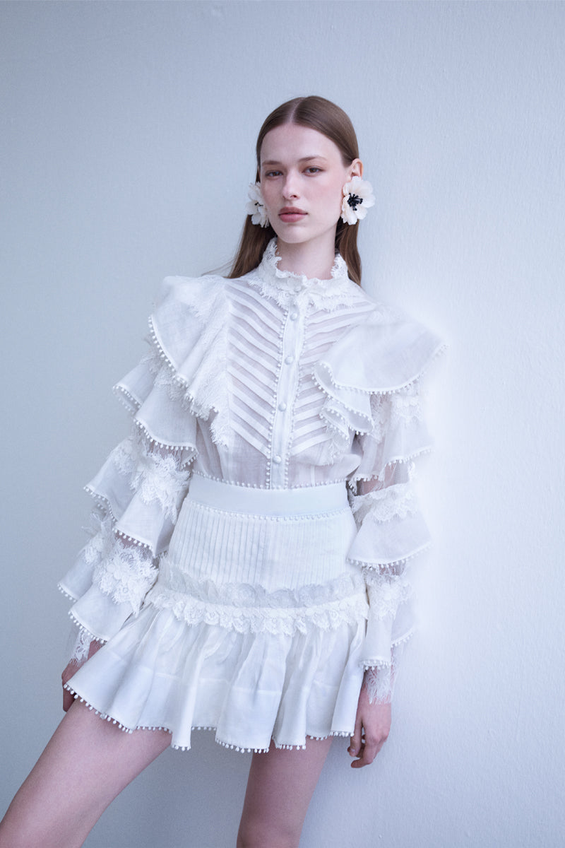 AISA pearl mini skirt with a fitted design and decorative pearl embellishments, shown on a neutral background.