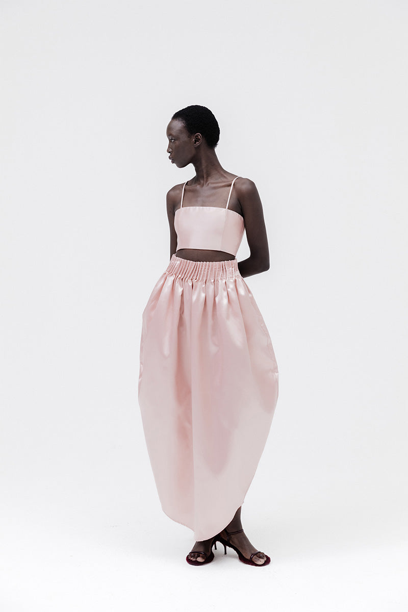 Pastel pink peony maxi skirt from Studio NK, flowing fabric with a feminine, elegant design, suitable for spring and summer outfits.