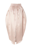 Pastel pink peony maxi skirt by Studio NK, flowing fabric with floral design, stylish and feminine for spring or summer wear.
