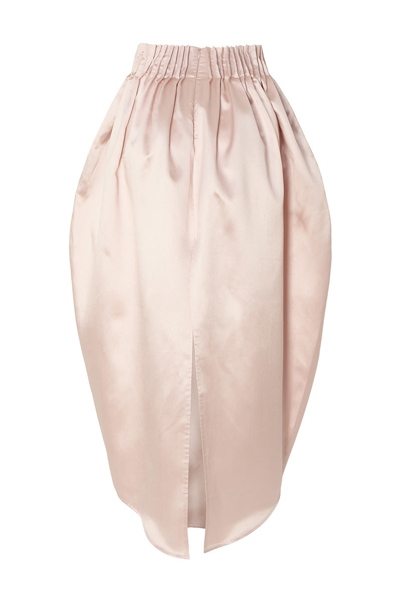 Pastel pink peony maxi skirt by Studio NK, flowing fabric with floral design, stylish and feminine for spring or summer wear.
