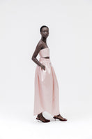 Studio NK Peony Top in pastel pink, lightweight women's blouse with a relaxed fit and feminine design, shown on a hanger.