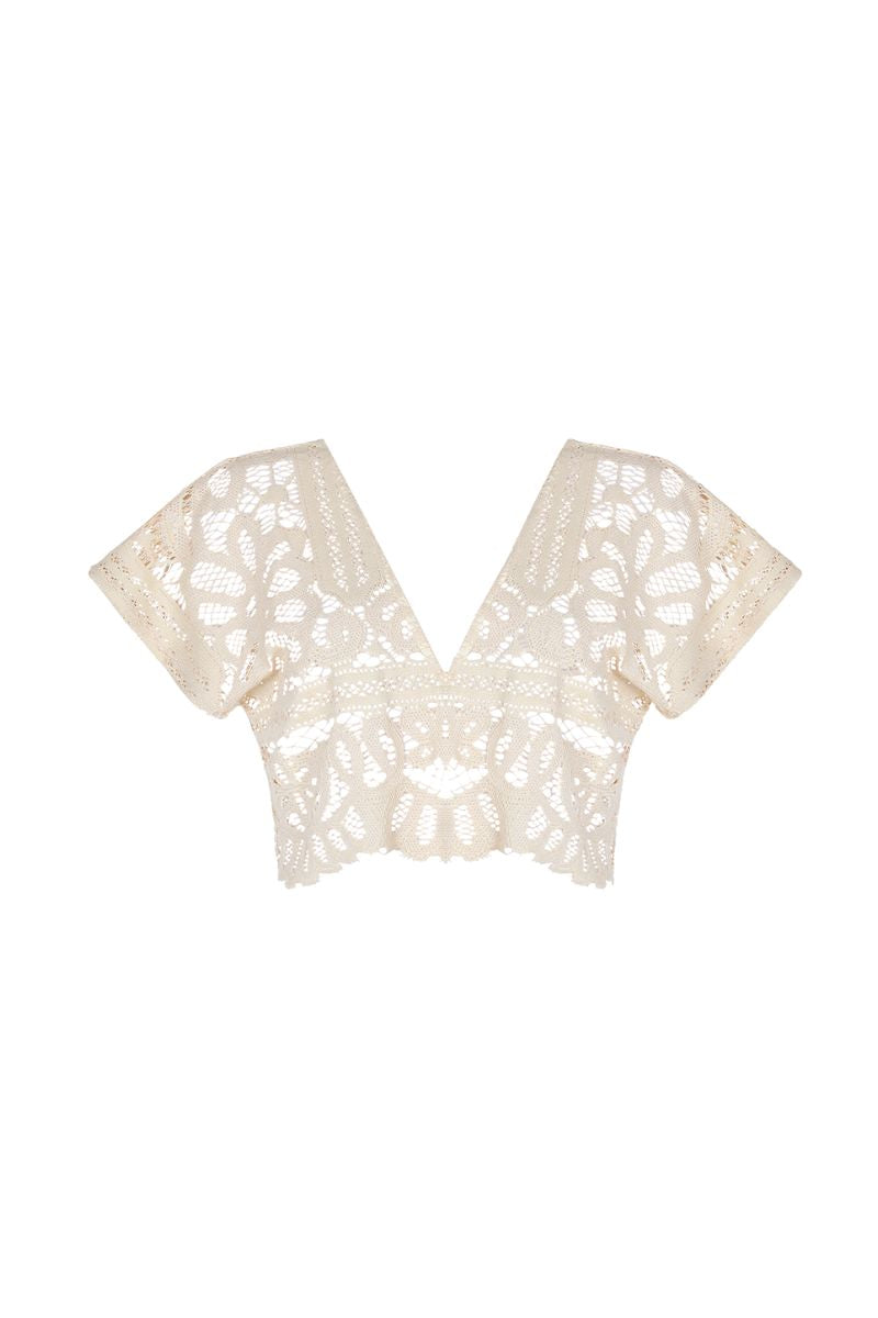 Aguaclara La Perle crop top in soft fabric, featuring a fitted design and stylish neckline, shown on a model.