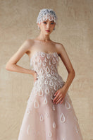 Elegant A-line sheer tulle gown by Phan Huy featuring hand-embroidered beads and flowing silhouette.