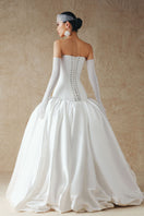 White cut-out silk Tafta gown by Phan Huy featuring elegant design and flowing fabric, perfect for formal occasions.