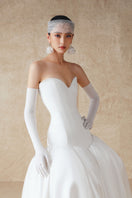 White cut-out silk gown by Phan Huy featuring a sleek design and elegant silhouette.