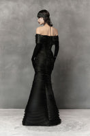 Long black cut-out gown by Phan Huy featuring a sleek silhouette and stylish cut-out details, perfect for elegant occasions.