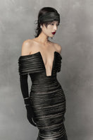 Long black cut-out gown by Phan Huy featuring a sleek silhouette and stylish cut-out details, perfect for elegant occasions.