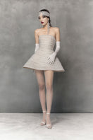 White mini tulle dress with metal beads by Phan Huy, featuring a delicate, airy fabric and intricate bead details.