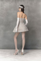 White mini tulle dress with metal beads by Phan Huy, featuring a stylish, lightweight design perfect for special occasions.