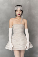 White mini tulle dress with metal beads by Phan Huy, featuring a stylish short design and delicate bead embellishments.