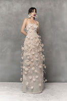 Elegant floral lace gown by Phan Huy featuring intricate beadwork and a flowing silhouette.