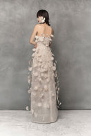 Elegant floral lace gown by Phan Huy with intricate lace, metallic bead details, and a flowing silhouette.