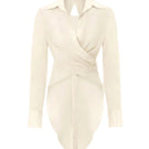 White Ulysse shirt by IKINITA, featuring a classic button-up design with a collar and long sleeves, displayed on a model.