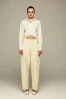 White Ulysse shirt by IKINITA, shown laid flat with long sleeves and classic collar, highlighting the clean, minimalist design.