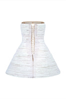 Back view of a white mini tulle dress with metal beads by Phan Huy, featuring a fitted silhouette and delicate fabric details.