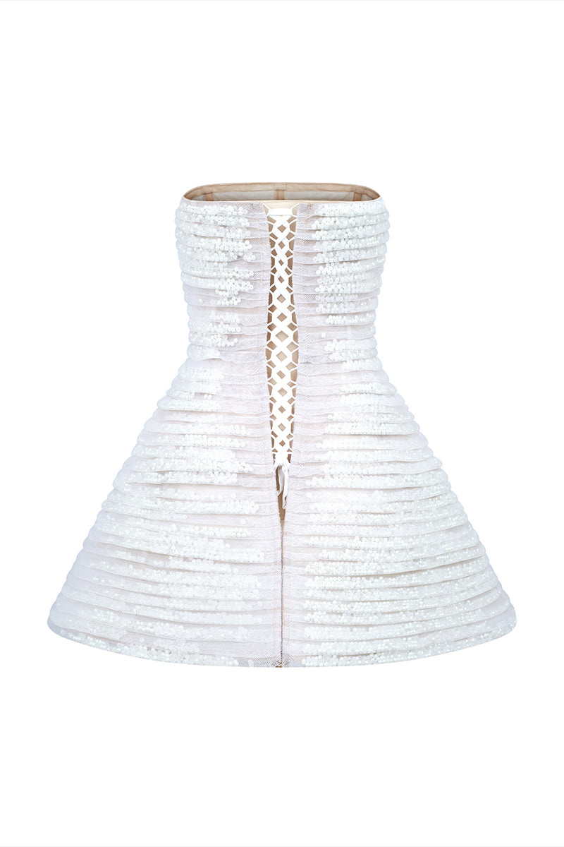 Back view of a white mini tulle dress with metal beads by Phan Huy, featuring a fitted silhouette and delicate fabric details.