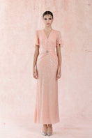 Pink sequin ruffle gown by HACCHIC COUTURE with layered ruffle details and shimmering sequins, perfect for formal occasions.