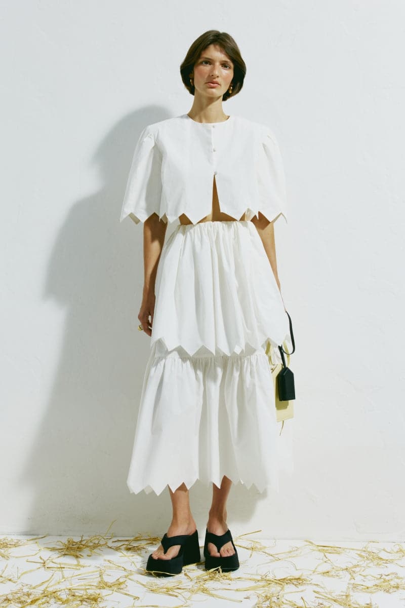 White crop top from PODYH's DZVINYTSYA collection, shown on a model with a fitted design and short sleeves.