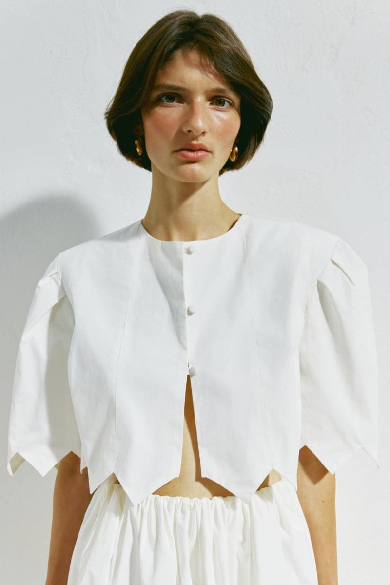 White crop top from PODYH's DZVINYTSYA collection, featuring a stylish, fitted design perfect for casual or trendy outfits.