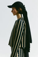 PODYH striped straight jacket with bold pattern, featuring a tailored fit and button details, styled for a modern look.