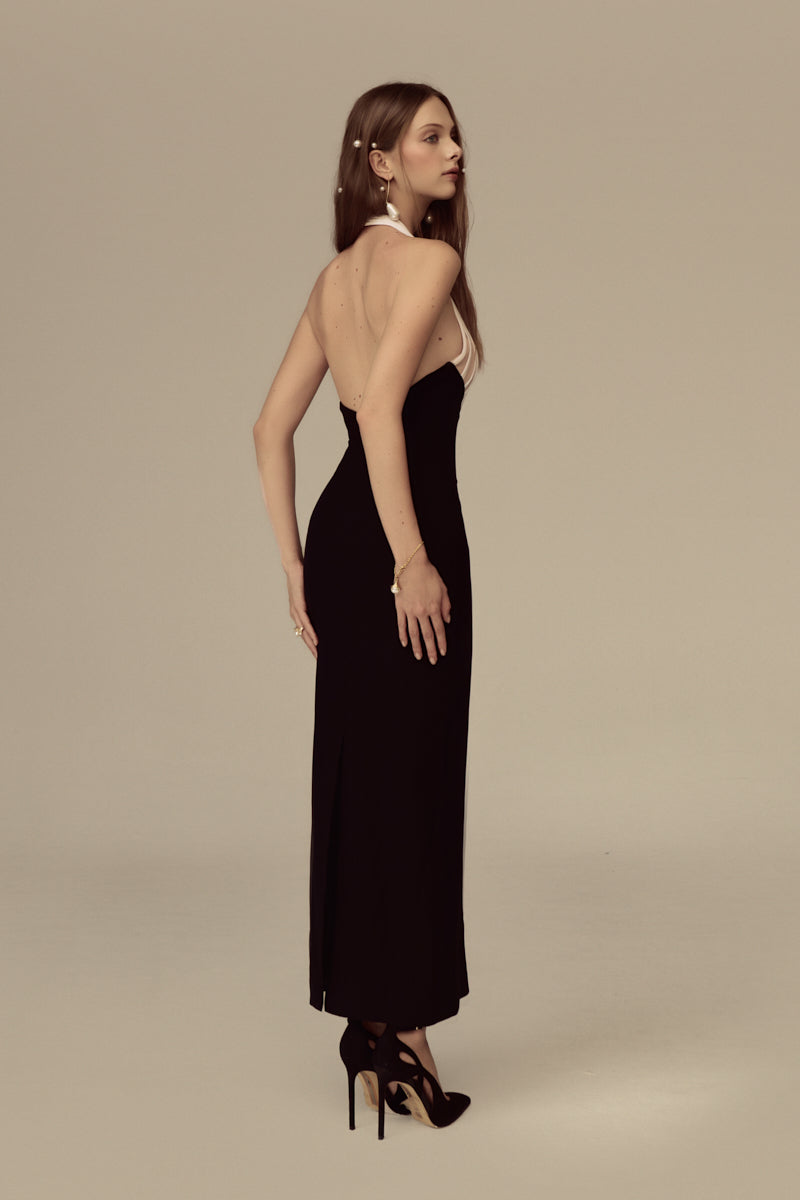 POEM AVELINE midi dress in soft fabric, knee-length design with elegant drape, styled with subtle floral pattern on a mannequin.