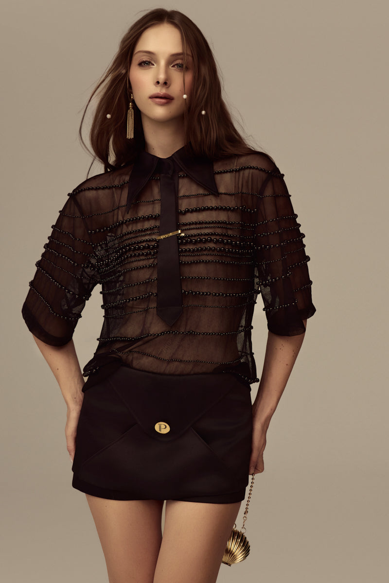 POEM Marabel mini skirt in black, stylish high-waisted design, with a fitted silhouette and subtle stitching details.