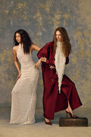 Elegant POEM Pearlescence gown with intricate beadwork and flowing fabric, ideal for formal occasions.