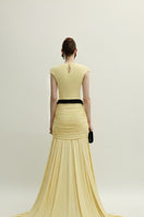 Yellow Primrose dress gown by Jenny K Tran, featuring elegant fabric and a flowing design, displayed on a mannequin.