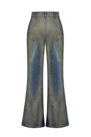 Back view of NADYA DZYAK flared jeans in rusty denim with a high waist and wide flare leg style.