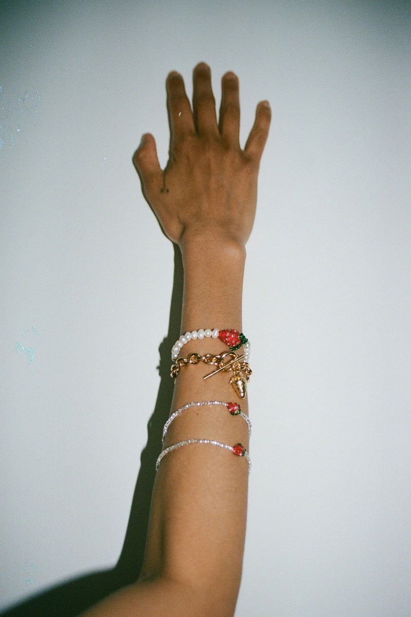 Pura Utz pearl strawberry bracelet featuring delicate pearl and strawberry charm on a stylish bracelet design.
