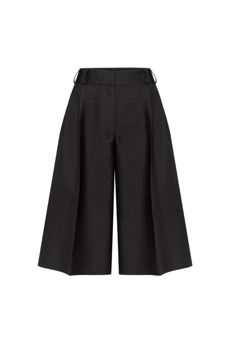 Serenity Paige black silk and wool blend shorts displayed on a hanger, showcasing the stylish and elegant design.