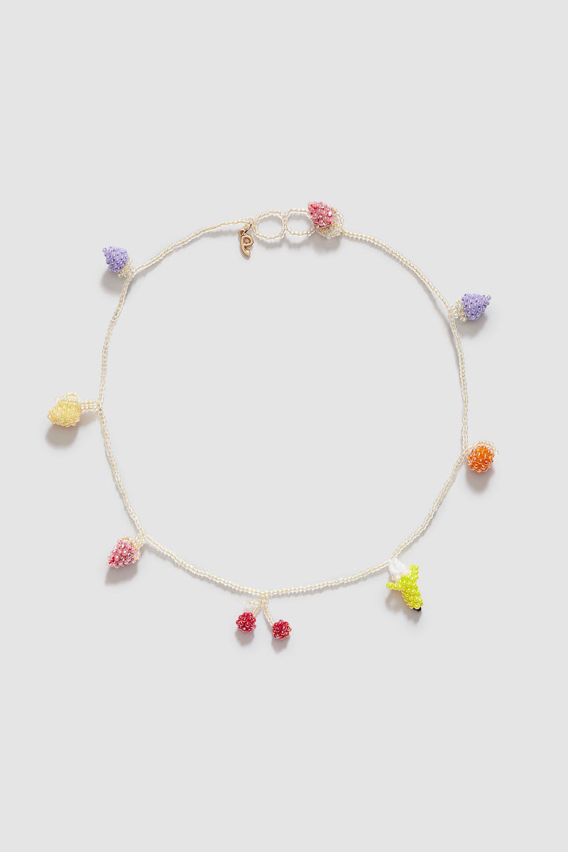 Pura Utz Pale Fruit Salad necklace featuring colorful, handcrafted fruit-shaped beads on a delicate chain.