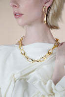 Sara Shala Palermo earrings in yellow gold vermeil with intricate design, shown on a white background.