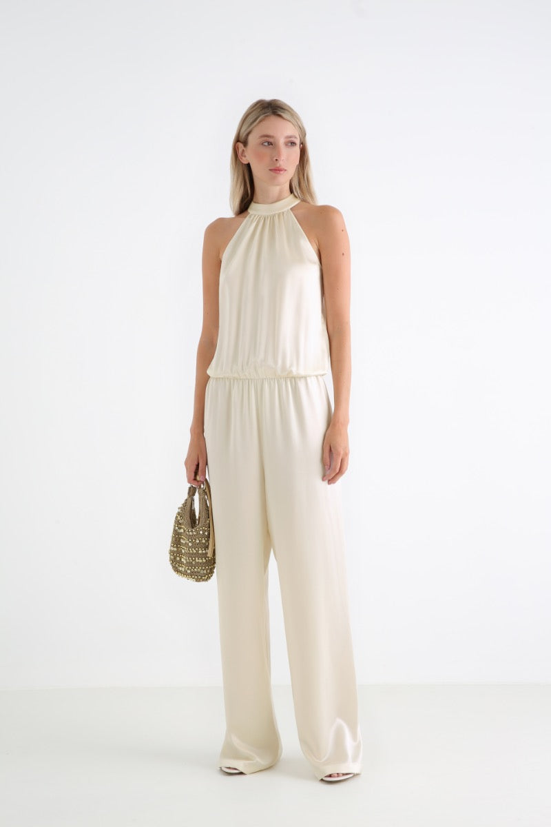 Serenity Palermo butter-cream silk-satin halter jumpsuit displayed on a hanger, highlighting elegant design and smooth fabric.