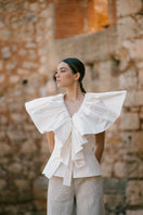 Ivory Palma blouse by ANA + MARIA, featuring lightweight fabric and stylish design, displayed on a model in a fashion campaign.